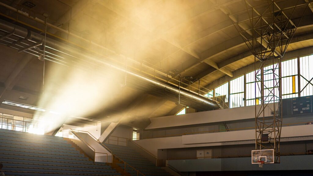 Empty indoors basketball court with sunset sunlight